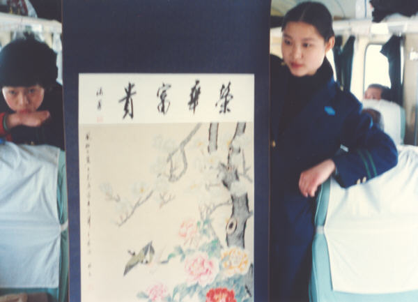 Train stewardesses hawking a scroll painting. Picture by Francis Chin