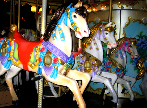Painted ponies go up and down in the carousel of time